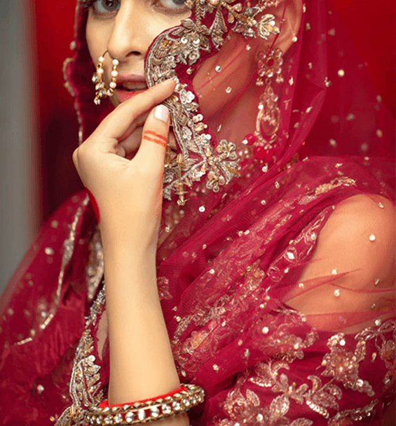 Bride in traditional red attire with gold embellishments