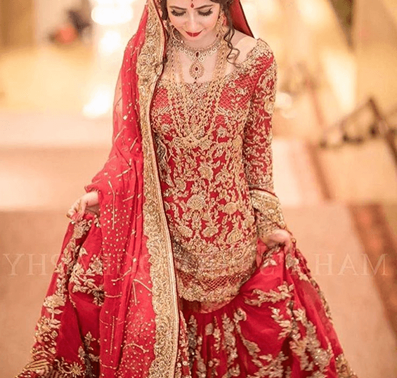 Bride in traditional red attire with gold embellishments