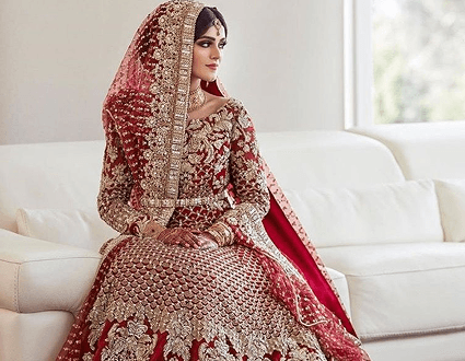 Bride in traditional red attire with gold embellishments
